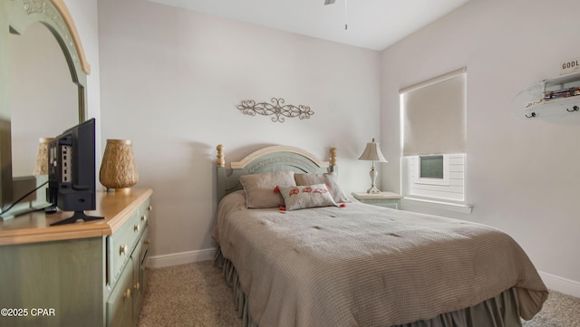 carpeted bedroom featuring baseboards and cooling unit