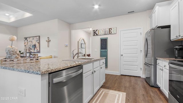 kitchen with visible vents, white cabinetry, and stainless steel appliances
