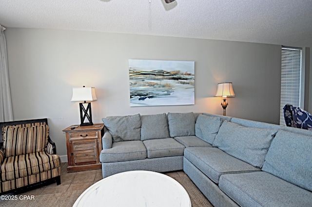 10811 Front Bch Unit 501, Panama City Beach, FL 32407 - living area featuring ceiling fan, a textured ceiling, and light tile patterned floors