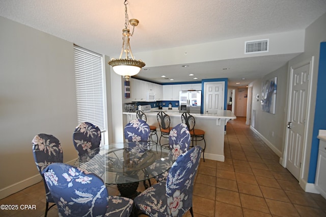 10811 Front Bch Unit 501, Panama City Beach, FL 32407 - dining area featuring tile patterned flooring and baseboards