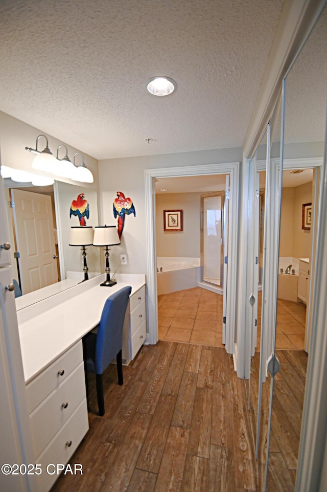 10811 Front Bch Unit 501, Panama City Beach, FL 32407 - office space with dark wood-style flooring, a textured ceiling, built in study area, and recessed lighting