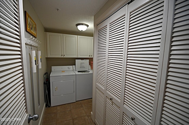 10811 Front Bch Unit 501, Panama City Beach, FL 32407 - laundry area with washer and clothes dryer, cabinet space, tile patterned flooring, and a textured ceiling