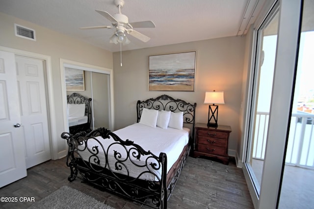 10811 Front Bch Unit 501, Panama City Beach, FL 32407 - bedroom featuring dark wood-style flooring, a ceiling fan, and a closet