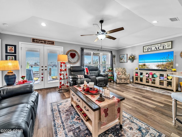 living room featuring visible vents, french doors, crown molding, and vaulted ceiling