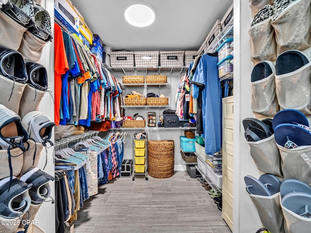 walk in closet featuring wood finish floors