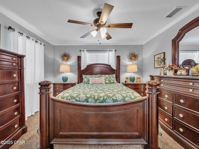 carpeted bedroom with visible vents, crown molding, and a ceiling fan