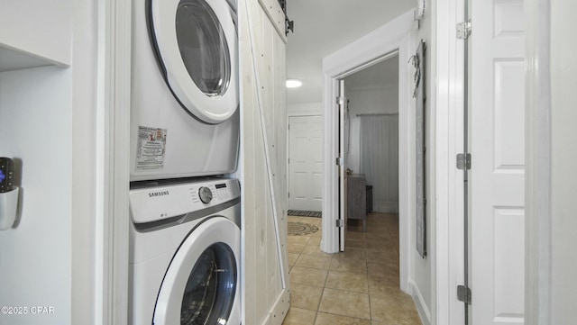 9450 S Thomas Unit 2106D, Panama City, FL 32408 - laundry area featuring stacked washer / dryer and light tile patterned flooring