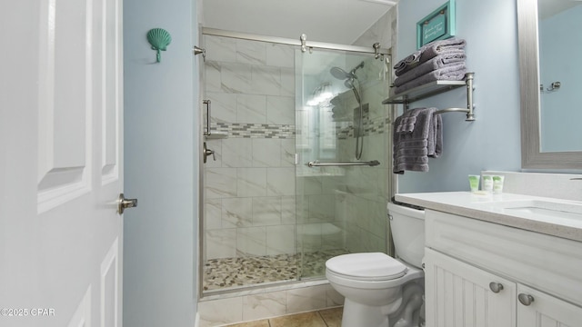 9450 S Thomas Unit 2106D, Panama City, FL 32408 - bathroom with vanity, toilet, a shower stall, and tile patterned flooring
