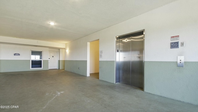 9450 S Thomas Unit 2106D, Panama City, FL 32408 - unfurnished room with elevator and finished concrete floors