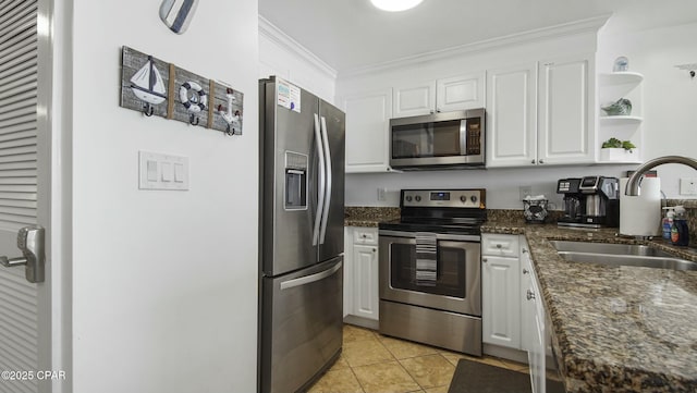 9450 S Thomas Unit 2106D, Panama City, FL 32408 - kitchen featuring appliances with stainless steel finishes, a sink, crown molding, white cabinets, and light tile patterned floors