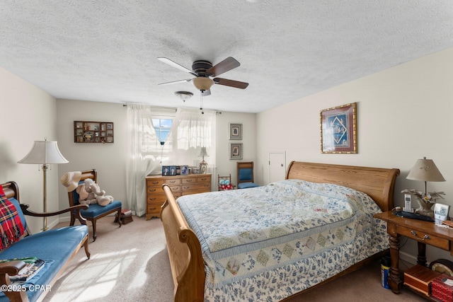 bedroom featuring carpet flooring, a ceiling fan, and a textured ceiling