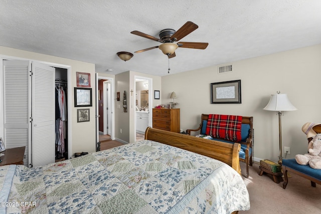 bedroom with visible vents, carpet floors, a textured ceiling, and a closet