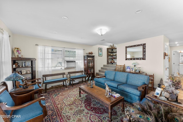 living area with stairs, cooling unit, and visible vents