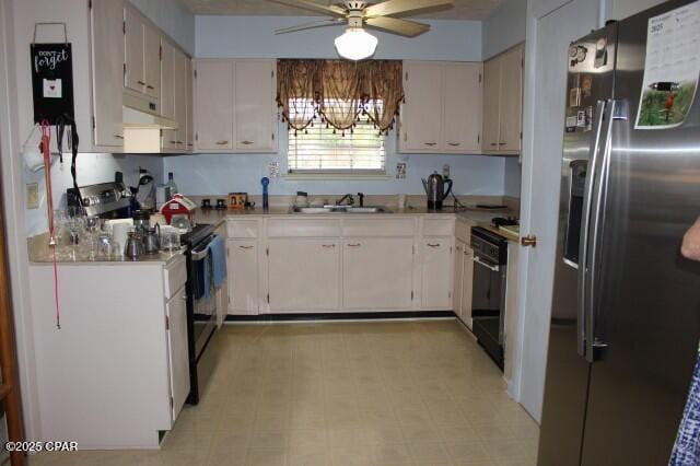 kitchen with a ceiling fan, light floors, a sink, stainless steel appliances, and under cabinet range hood