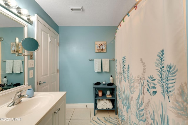 full bath with tile patterned flooring, visible vents, baseboards, vanity, and a textured ceiling