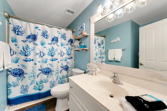 full bathroom featuring visible vents, toilet, wood finished floors, a shower with shower curtain, and vanity