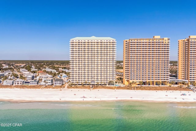 birds eye view of property with a view of city, a beach view, and a water view