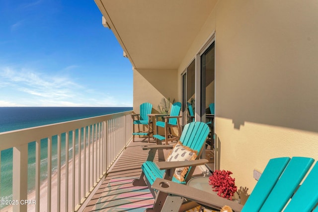 balcony with a beach view and a water view