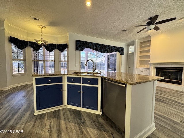 kitchen with dark wood-style floors, visible vents, dishwasher, and a sink