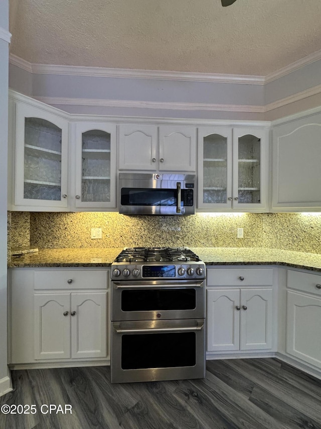 kitchen featuring tasteful backsplash, appliances with stainless steel finishes, and white cabinets