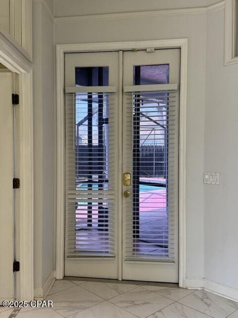 doorway with marble finish floor, french doors, and baseboards