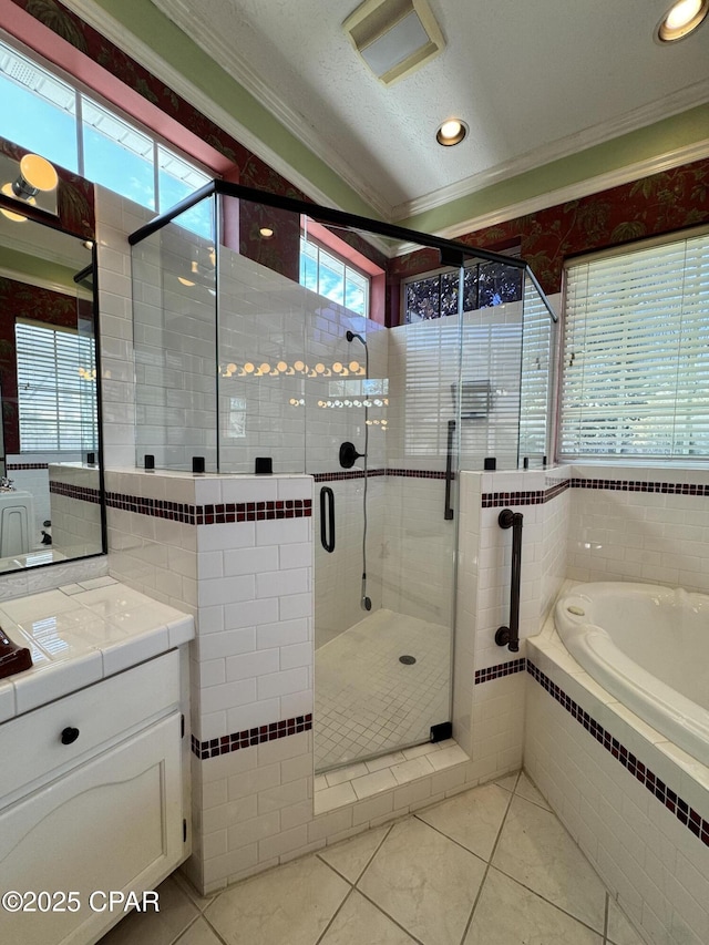 bathroom with a shower stall, vanity, a garden tub, ornamental molding, and a textured ceiling