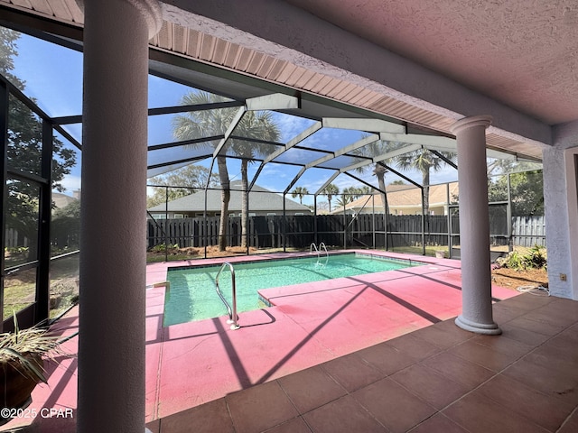 view of swimming pool featuring a lanai, a fenced in pool, a fenced backyard, and a patio area