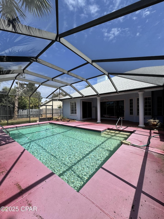 view of swimming pool featuring a patio area, a fenced in pool, a lanai, and fence