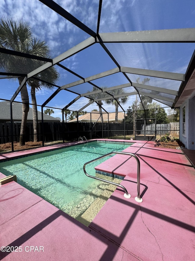 view of swimming pool with a lanai, a fenced in pool, a patio, and a fenced backyard