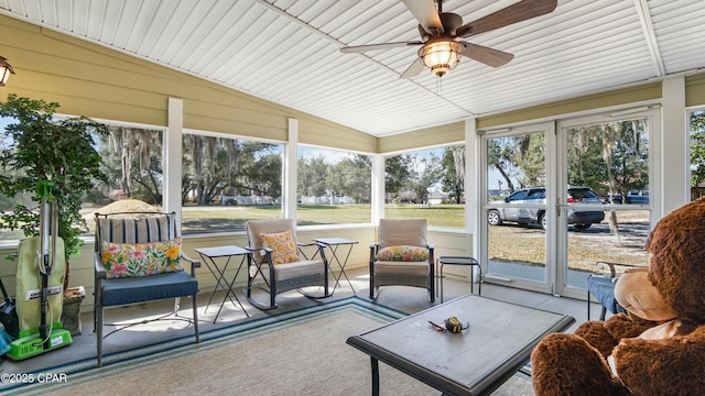 sunroom with a healthy amount of sunlight, lofted ceiling, and a ceiling fan