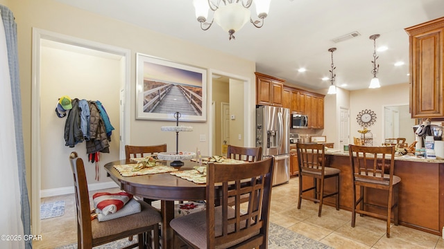 dining space with a notable chandelier, visible vents, baseboards, and light tile patterned floors