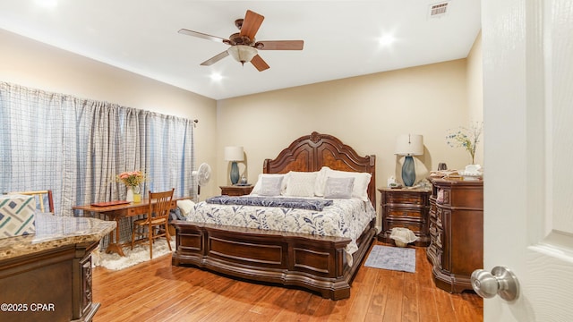 bedroom with visible vents, light wood finished floors, and ceiling fan