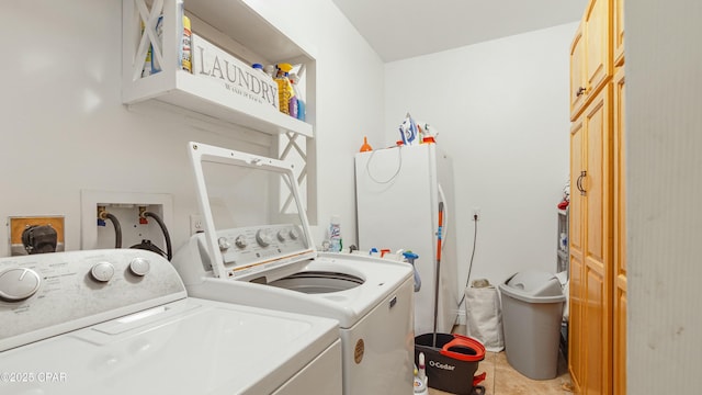 washroom featuring light tile patterned flooring, laundry area, and independent washer and dryer