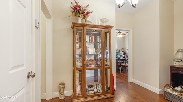 hallway with baseboards and wood finished floors