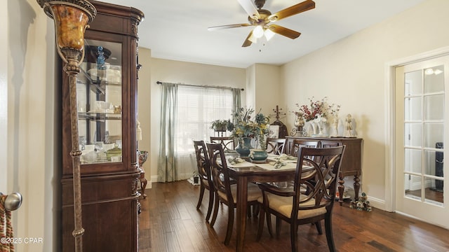 dining space featuring dark wood-type flooring, baseboards, and ceiling fan