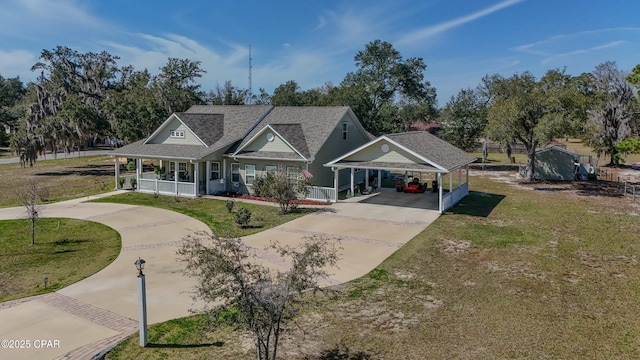 view of front facade with a carport, a porch, driveway, and a front lawn