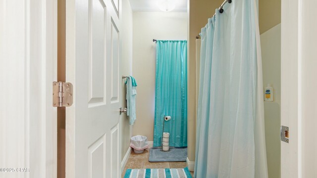 bathroom featuring baseboards and tile patterned flooring