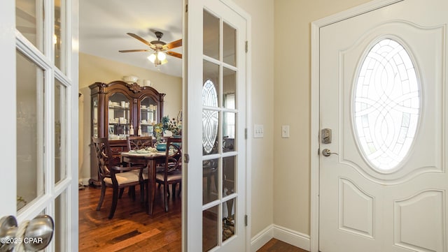 foyer featuring french doors, baseboards, dark wood-type flooring, and ceiling fan