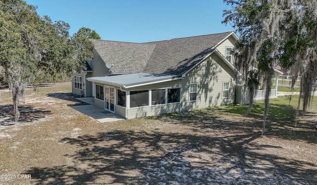 view of front of property with metal roof and a sunroom