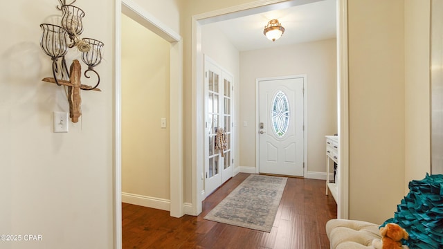 entryway with baseboards and dark wood-type flooring