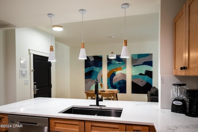 kitchen featuring stainless steel dishwasher, hanging light fixtures, a sink, a peninsula, and light stone countertops
