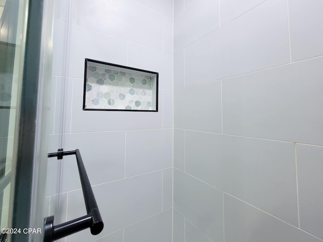 bathroom with tiled shower