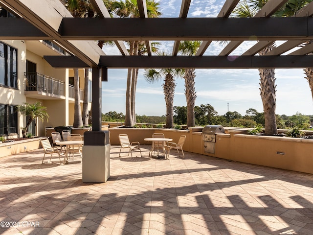 view of patio / terrace with a pergola, outdoor dining area, area for grilling, and a grill