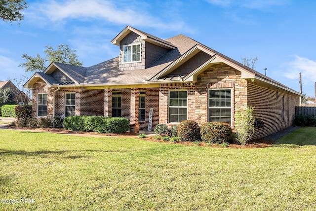 view of front facade with brick siding and a front lawn