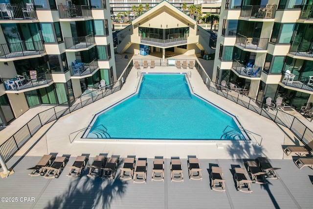 view of swimming pool with fence