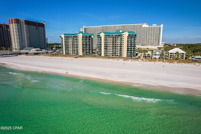 view of building exterior with a view of city, a view of the beach, and a water view