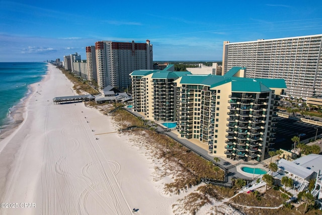 aerial view featuring a city view, a view of the beach, and a water view