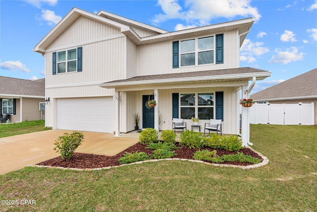 traditional-style home featuring a front yard, fence, driveway, a porch, and an attached garage