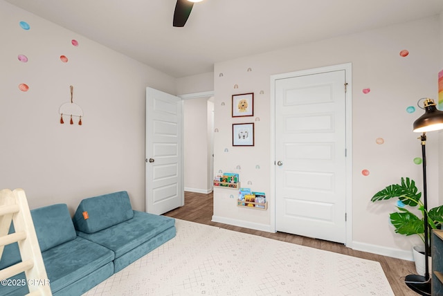 bedroom with wood finished floors, baseboards, and ceiling fan