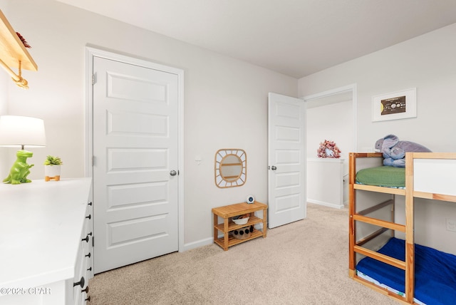 bedroom featuring baseboards and light carpet